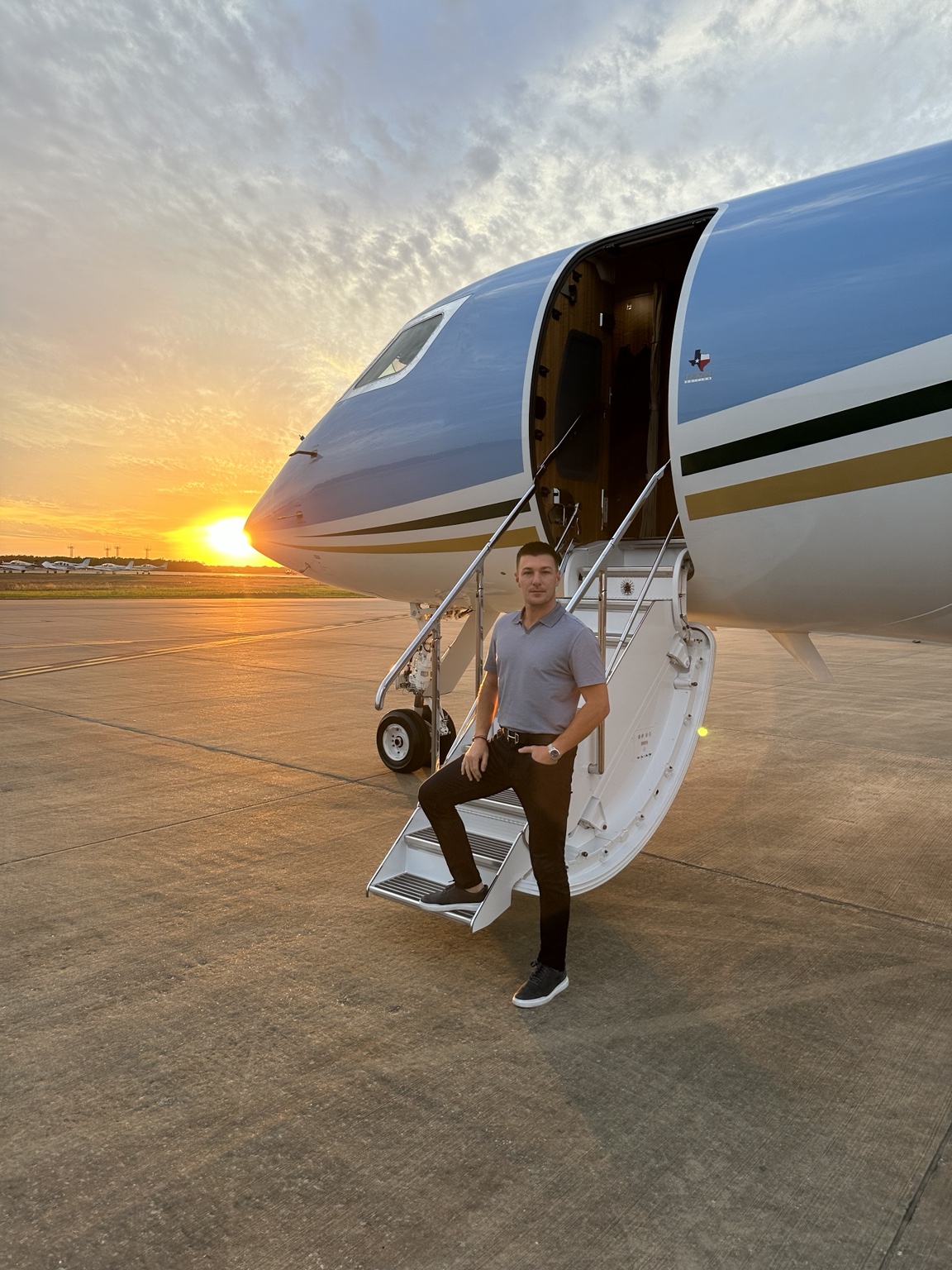 Joshua Anderson beside a large-cabin business jet at sunset